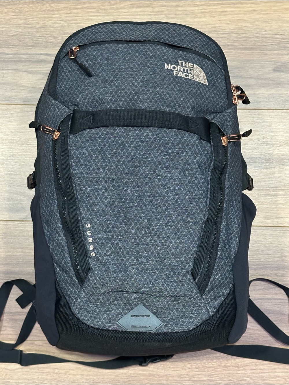The North Face Surge Backpack in TNF Black Heather Copper/TNF Black